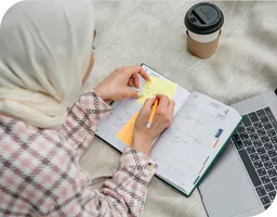 Woman writing on her calendar