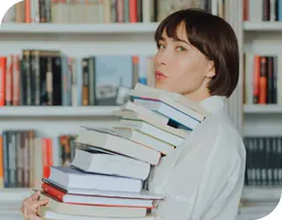 Woman carrying a stack of books