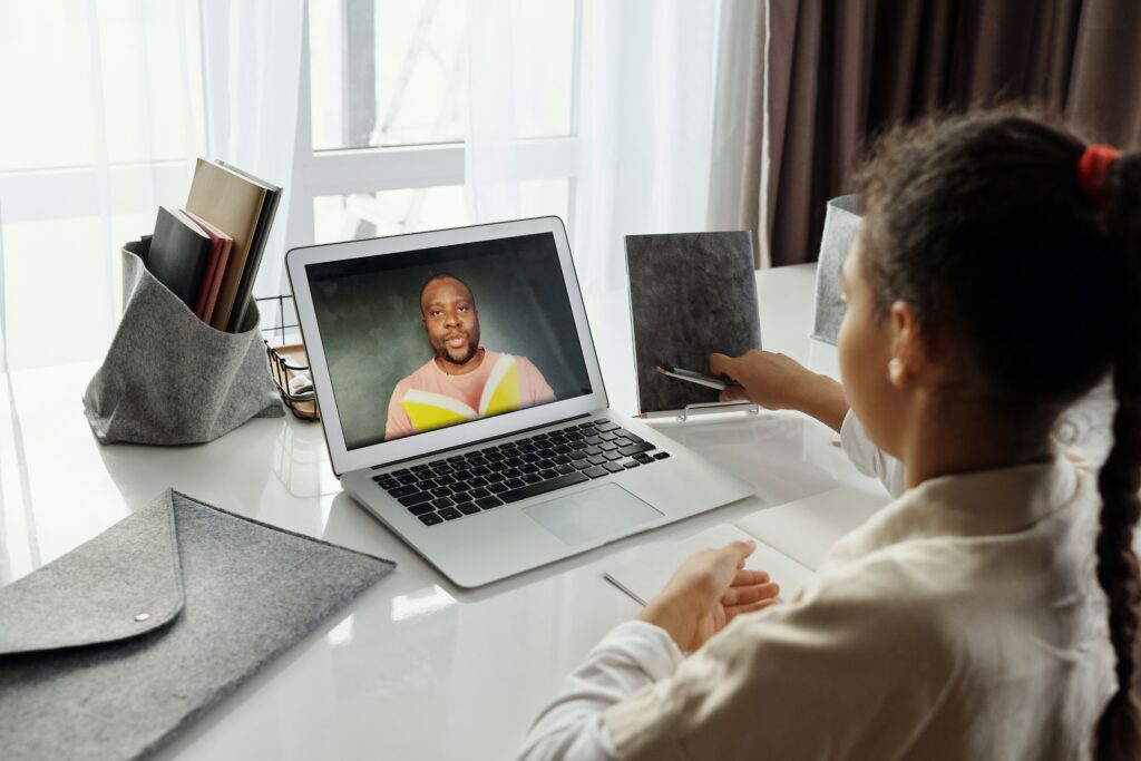 Young girl on video chat with a teacher